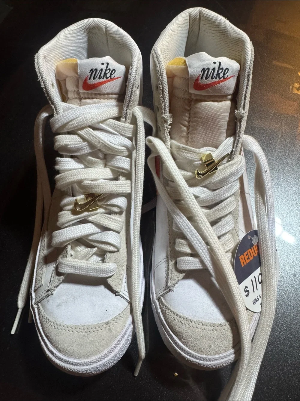Nike White High-Top Sneakers with Orange Swoosh